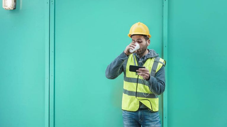 A builder using a mobile device outside