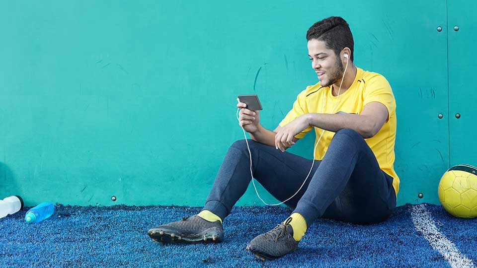 Man sitting on the floor using a mobile device