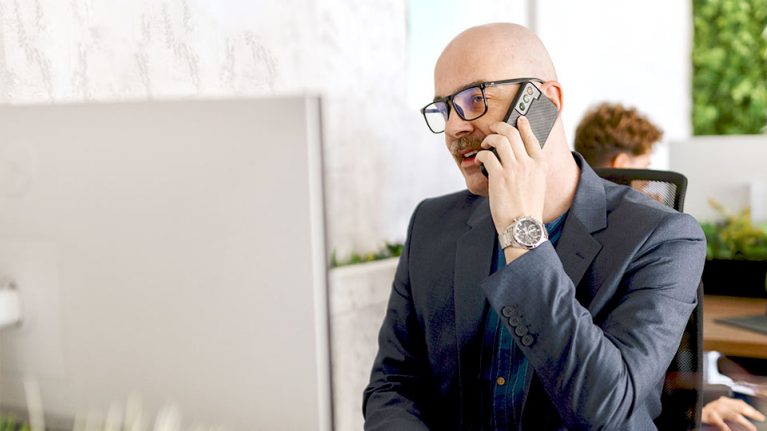 Man using mobile phone in office