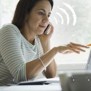 Employee on the phone at their desk using WiFi calling