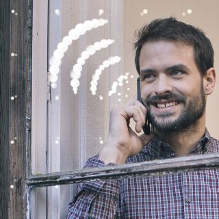 Employee on the phone by a window using WiFi calling