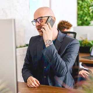 Man making phone call on mobile phone in office