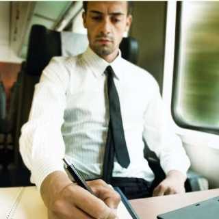 Employee in business attire using a notepad and pen on the train