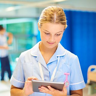 Nurse using tablet computer