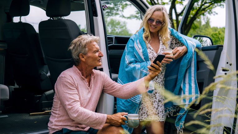 Man and woman looking on mobile device