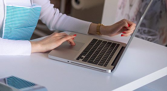 Close-up on woman using laptop