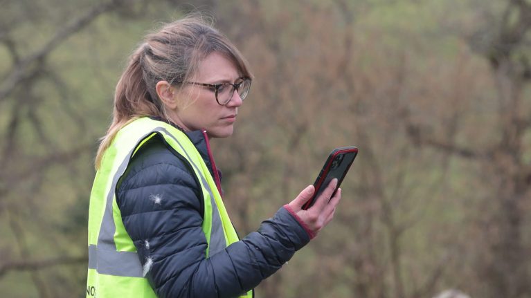 Woman outside looking at mobile phone