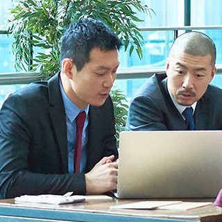 Two men looking at laptop