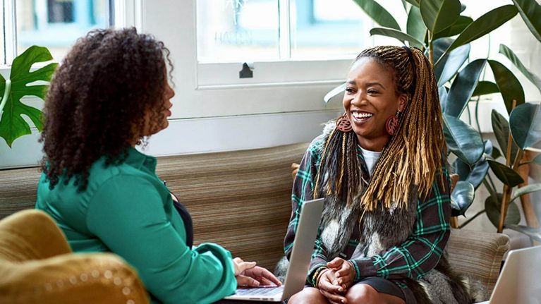 Two women talking in office