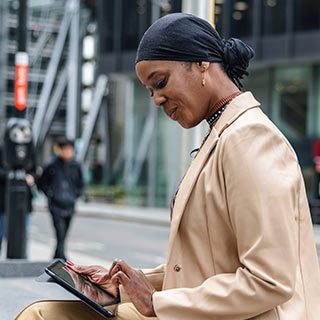 Woman typing on tablet PC