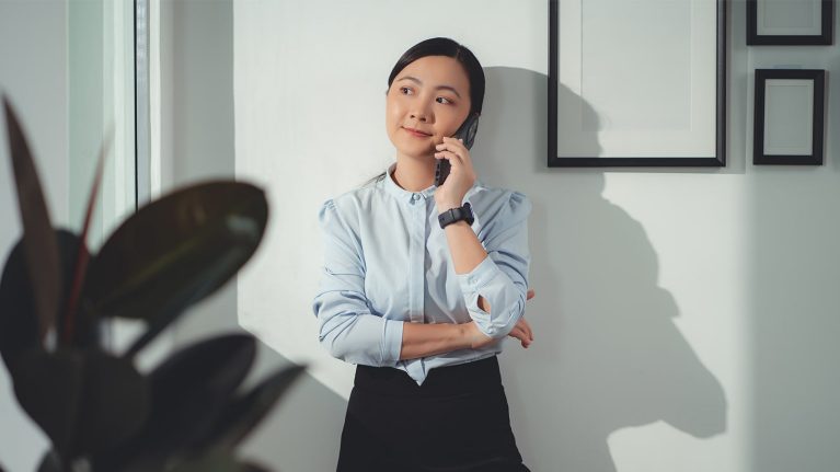 Woman on mobile phone in office