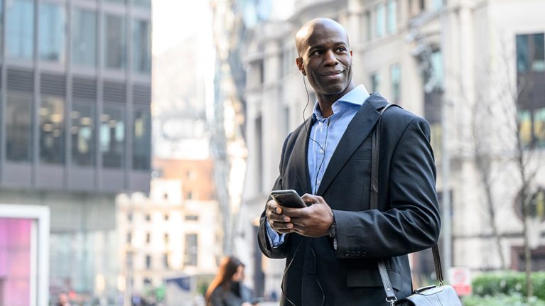 Employee using his mobile phone in the street