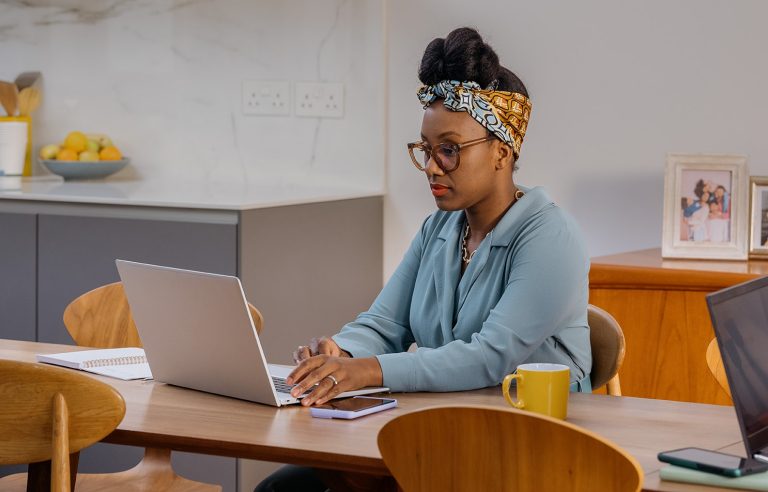 A woman working on her laptop remotely