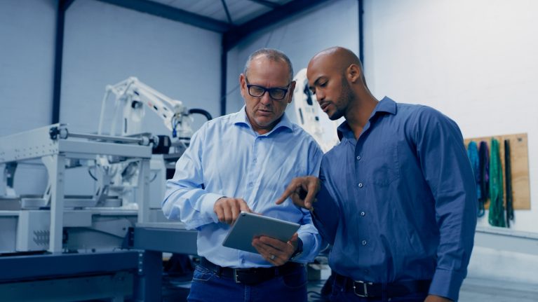 Two men looking at tablet