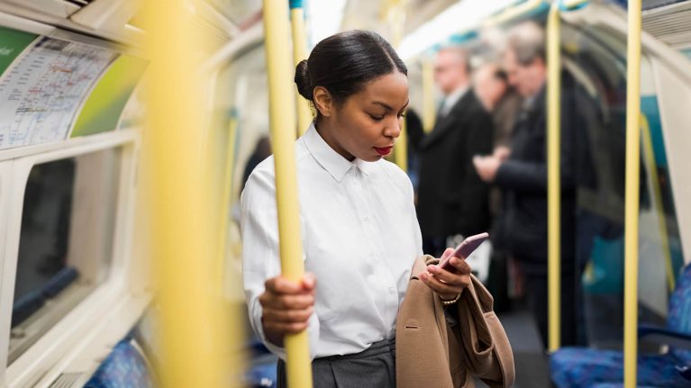 Woman using phone on train