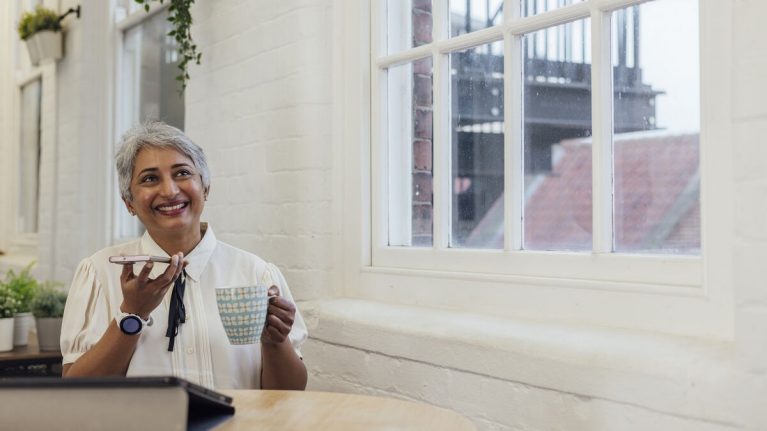 Woman using mobile in office