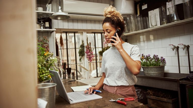 Woman using laptop & mobile