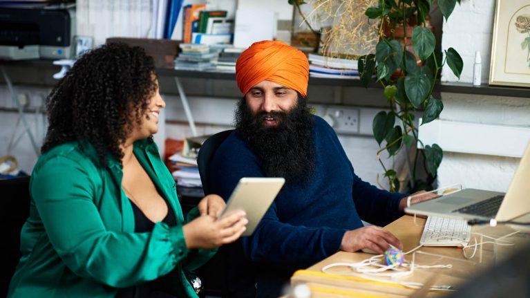 Man & woman looking at tablet