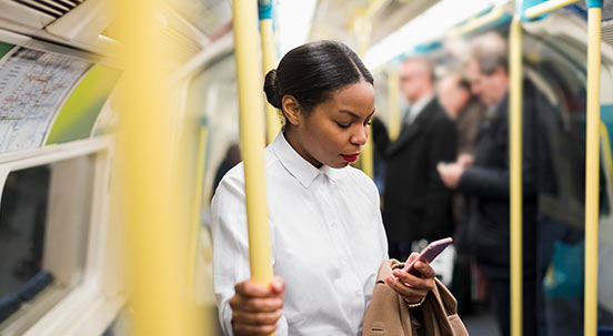 Woman using phone on train
